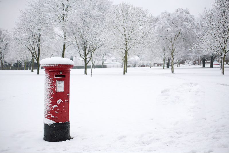 Red UK postbox in winter representing Direct Mail Trends 2025 and rising mail engagement.